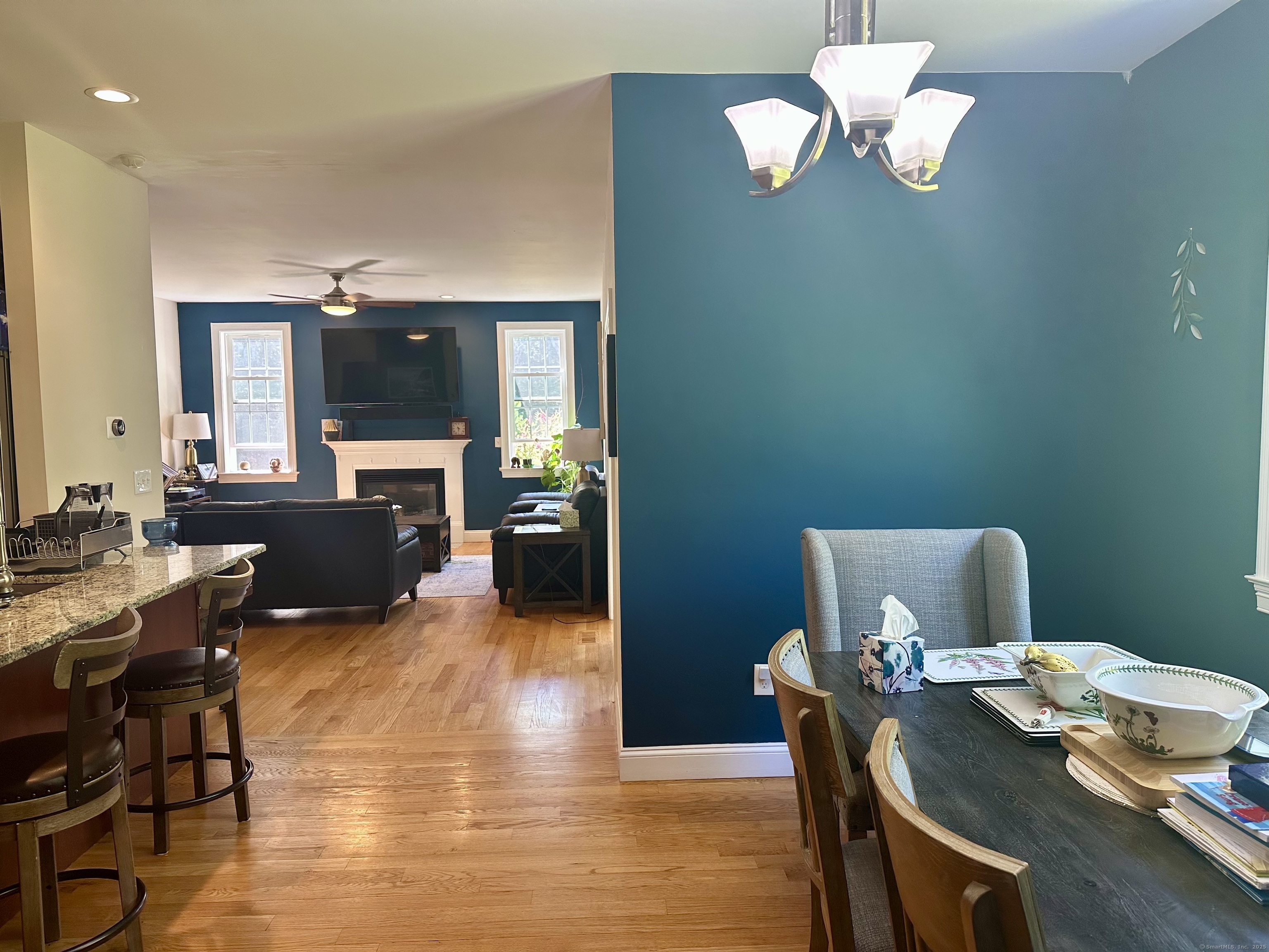 102 Pheasant Lane Granby, CT 06060 - Photo 8 of 33 a view of a dining room with furniture a chandelier and wooden floor