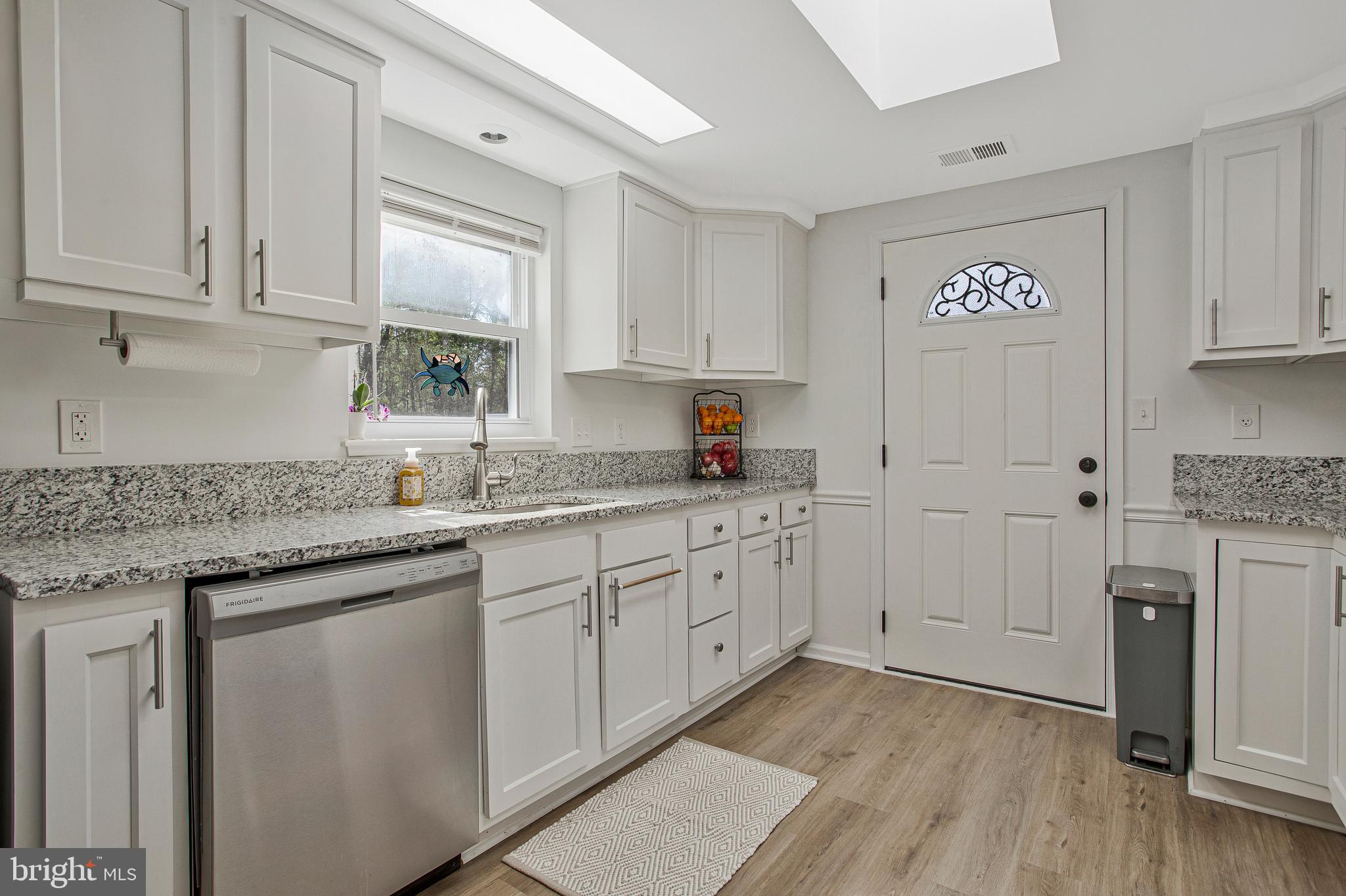 114 River Road Edgewater, MD 21037 - Photo 11 of 30 a kitchen with granite countertop white cabinets and white appliances