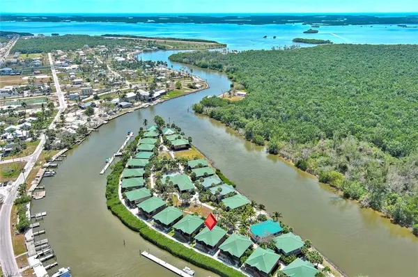 an aerial view of lake and residential houses with outdoor space