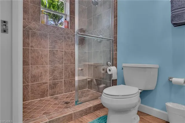 a bathroom with a toilet and a shower