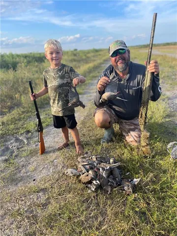 a view of a swimming pool with a table and chairs