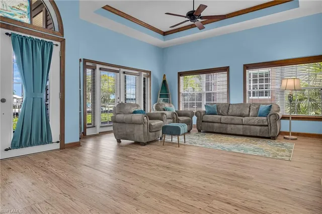 a living room with furniture ceiling fan and a window