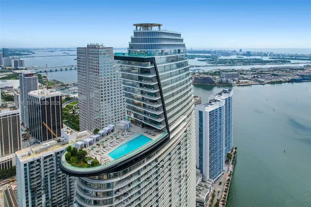 a view of a large building and a potted plant on the wall