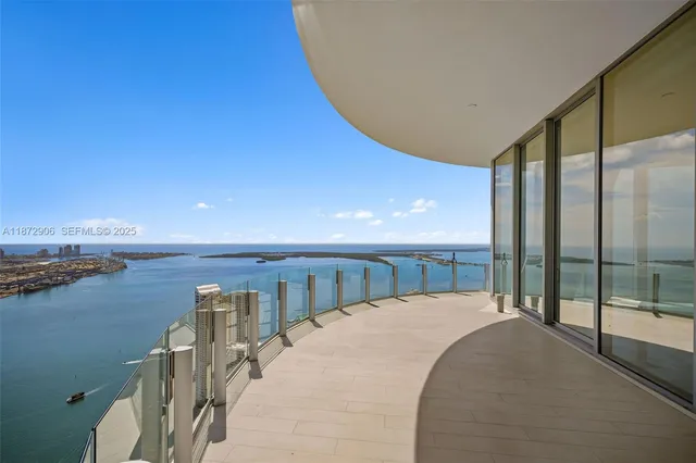 a spacious bedroom with a bed a mirror and a window
