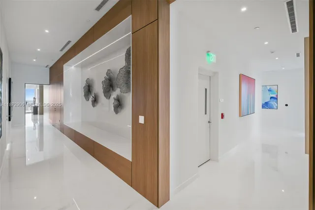 a living room with furniture kitchen view and a large window