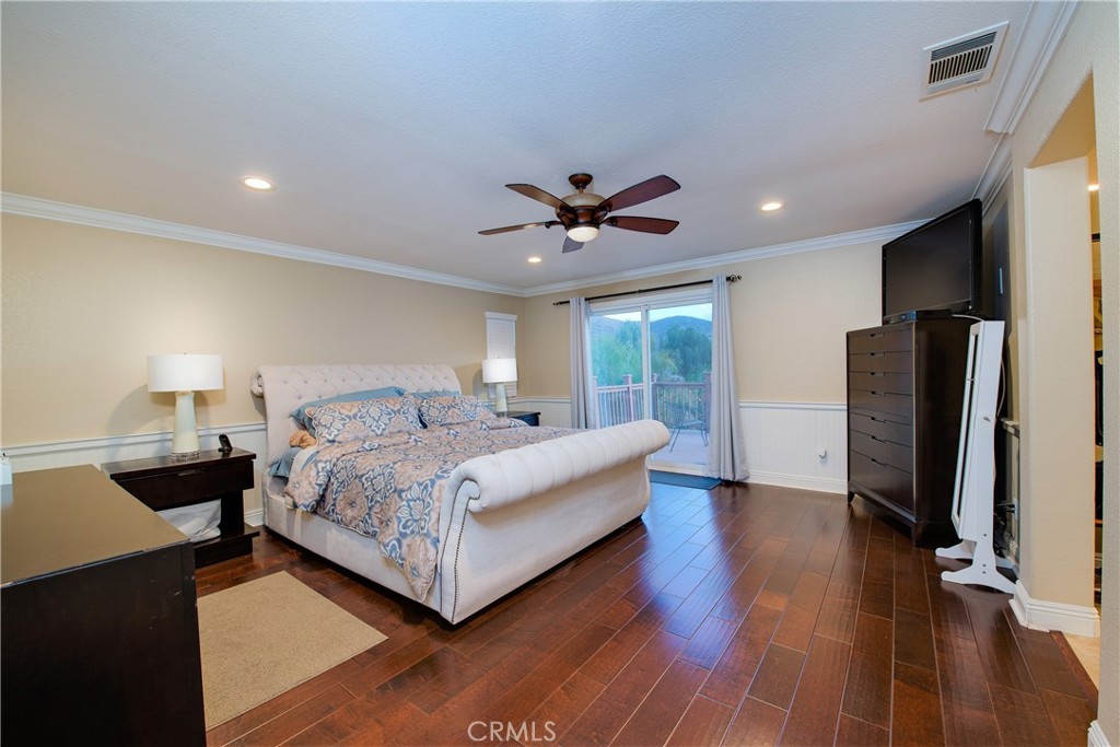 16163 Setting Sun Circle Riverside, CA 92503 - Photo 18 of 36 a bed room with a bed and a ceiling fan