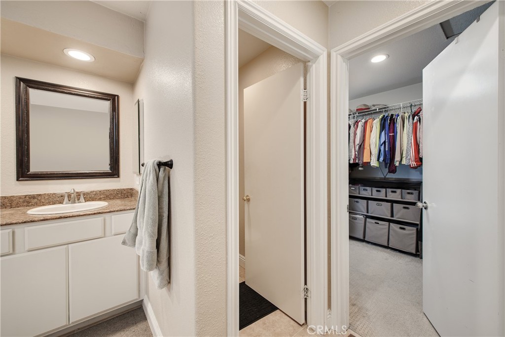 16163 Setting Sun Circle Riverside, CA 92503 - Photo 20 of 36 a view of walk in closet with clothes and shoes