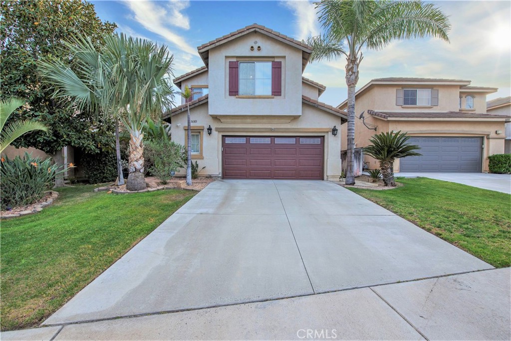 16163 Setting Sun Circle Riverside, CA 92503 - Photo 3 of 36 a front view of a house with a yard and garage