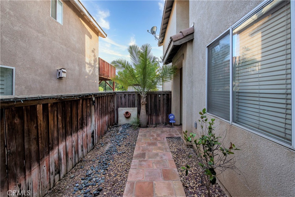 16163 Setting Sun Circle Riverside, CA 92503 - Photo 5 of 36 a backyard of a house with potted plants and wooden fence