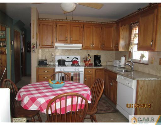 19 Montview Road Edison, NJ 08837 - Photo 3 of 15 a kitchen with a stove a sink and cabinets