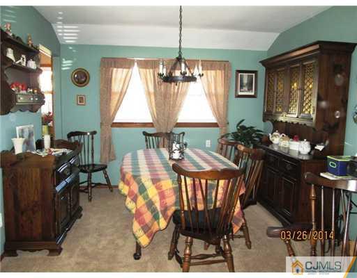 19 Montview Road Edison, NJ 08837 - Photo 5 of 15 a dining room with furniture a rug and a chandelier