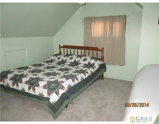 19 Montview Road Edison, NJ 08837 - Photo 9 of 15 a bed sitting in a bedroom next to a window