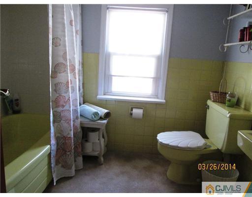 19 Montview Road Edison, NJ 08837 - Photo 10 of 15 a bathroom with a toilet a sink and a window