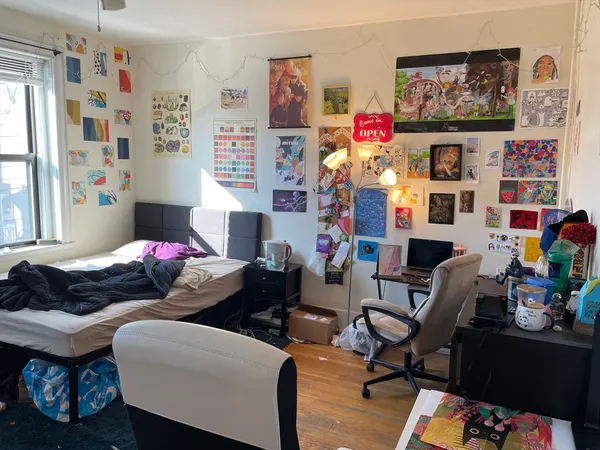 a living room with furniture and a bookshelf