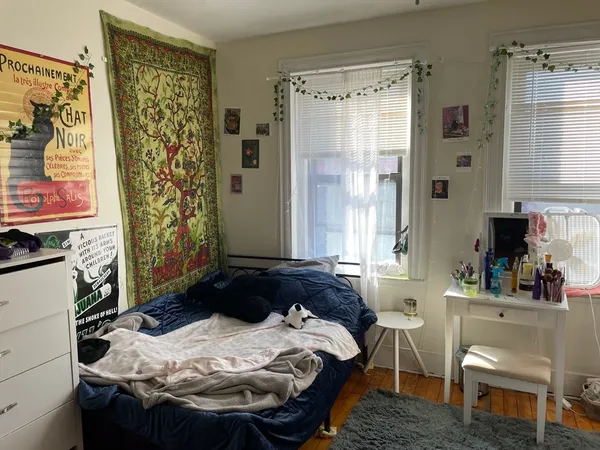 a bedroom with a bed and a window