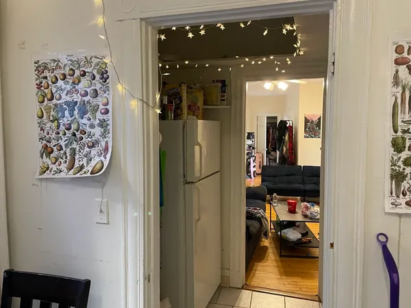 a view of a hallway with a view of living room