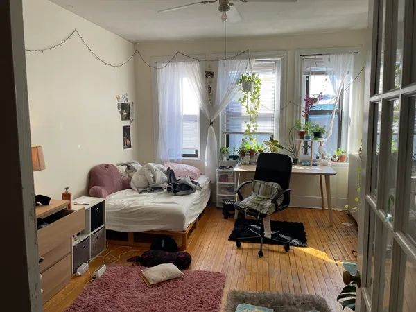 a bedroom with furniture and a window