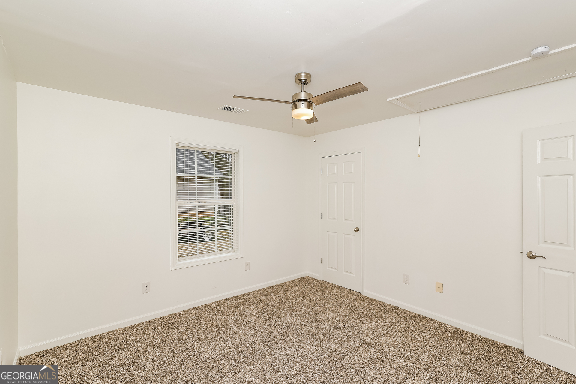 138 Pope Lane Newnan, GA 30263 - Photo 17 of 25 an empty room with windows and fan