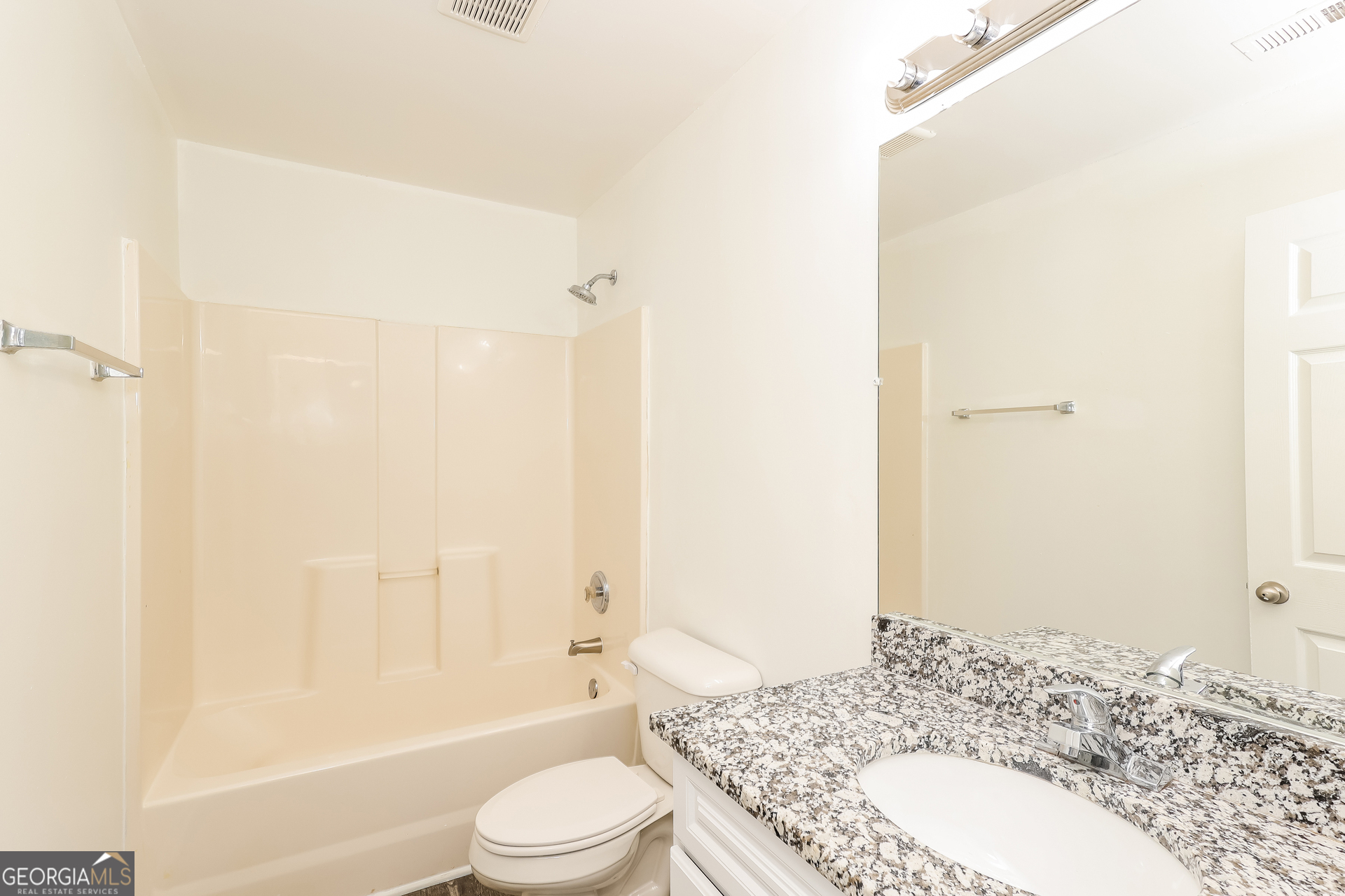 138 Pope Lane Newnan, GA 30263 - Photo 22 of 25 a bathroom with a granite countertop sink toilet and shower
