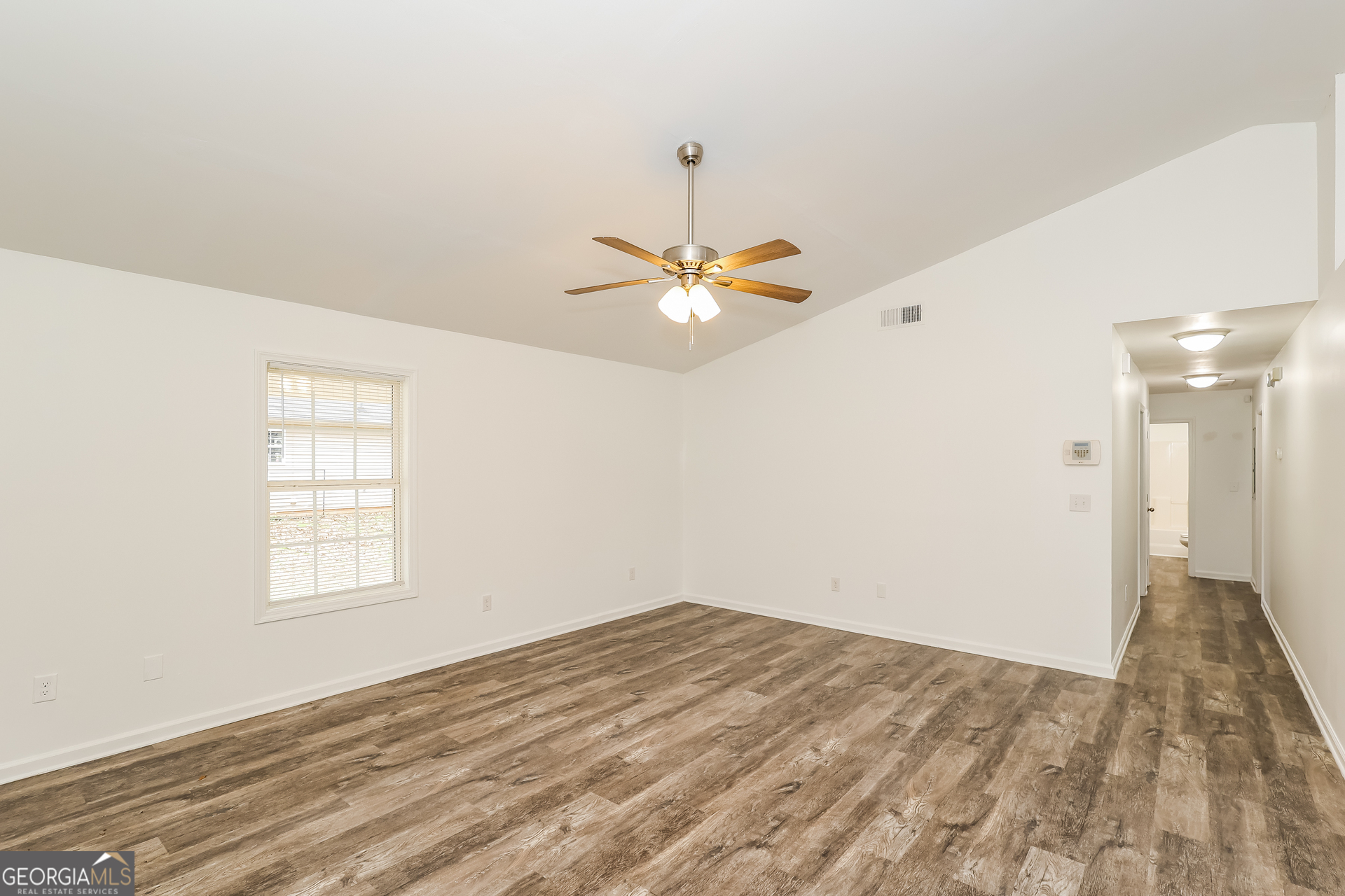 138 Pope Lane Newnan, GA 30263 - Photo 7 of 25 an empty room with a window and a ceiling fan
