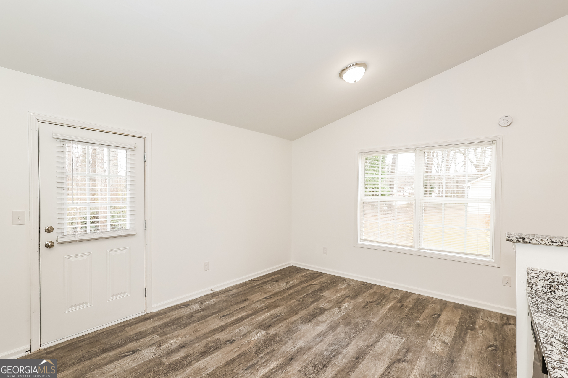 138 Pope Lane Newnan, GA 30263 - Photo 8 of 25 an empty room with wooden floor and windows