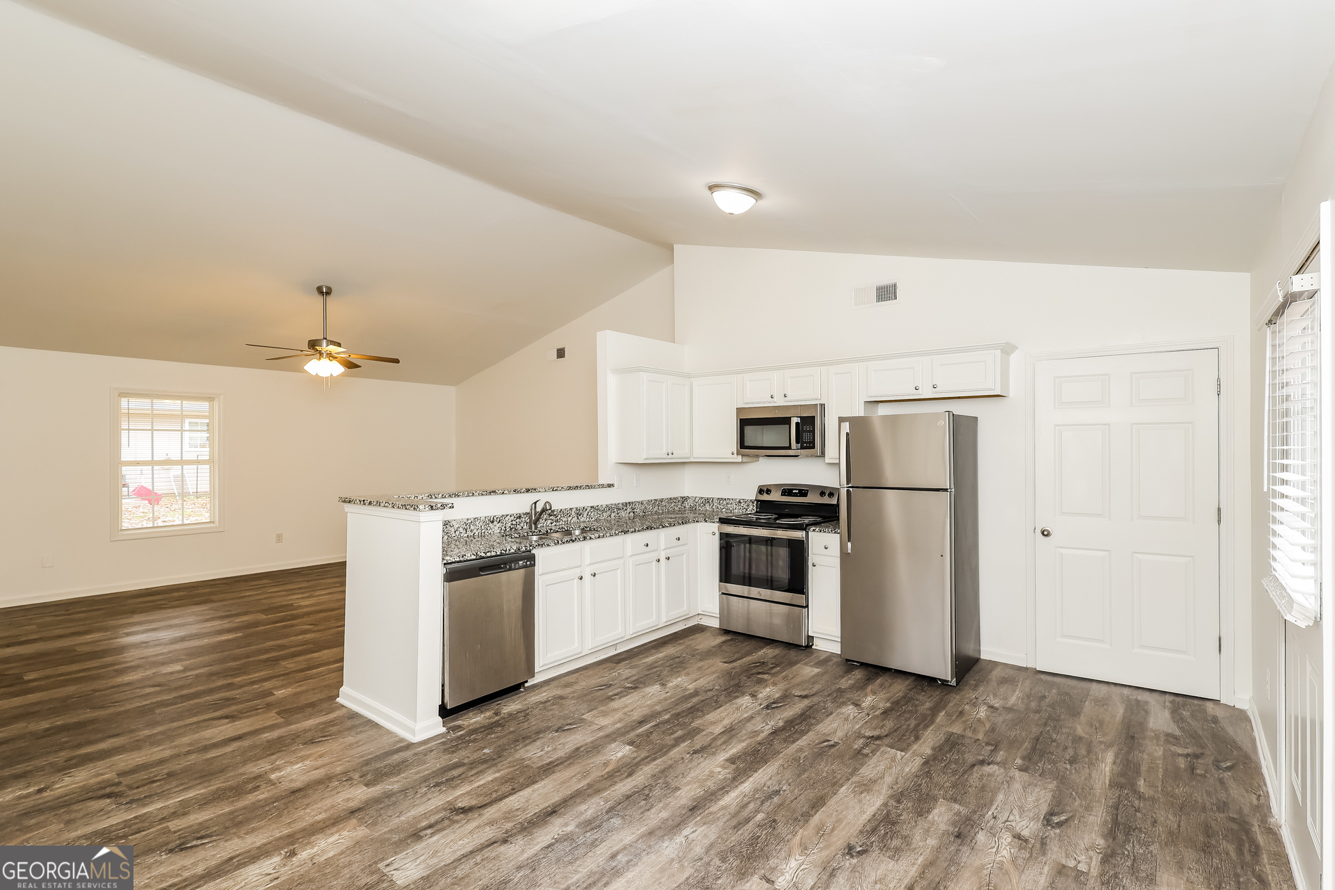 138 Pope Lane Newnan, GA 30263 - Photo 10 of 25 a kitchen with granite countertop a refrigerator stove top oven and sink