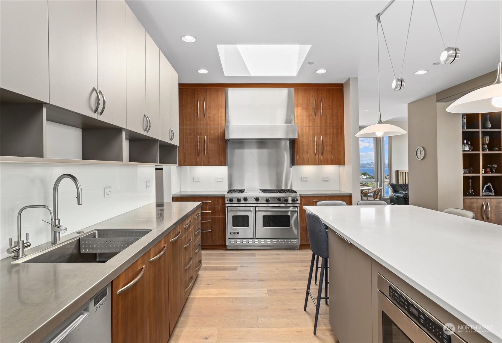 1661 Harbor Avenue Southwest, Unit 600 Seattle, WA 98126 - Photo 16 of 40 a kitchen with stainless steel appliances a sink stove and cabinets