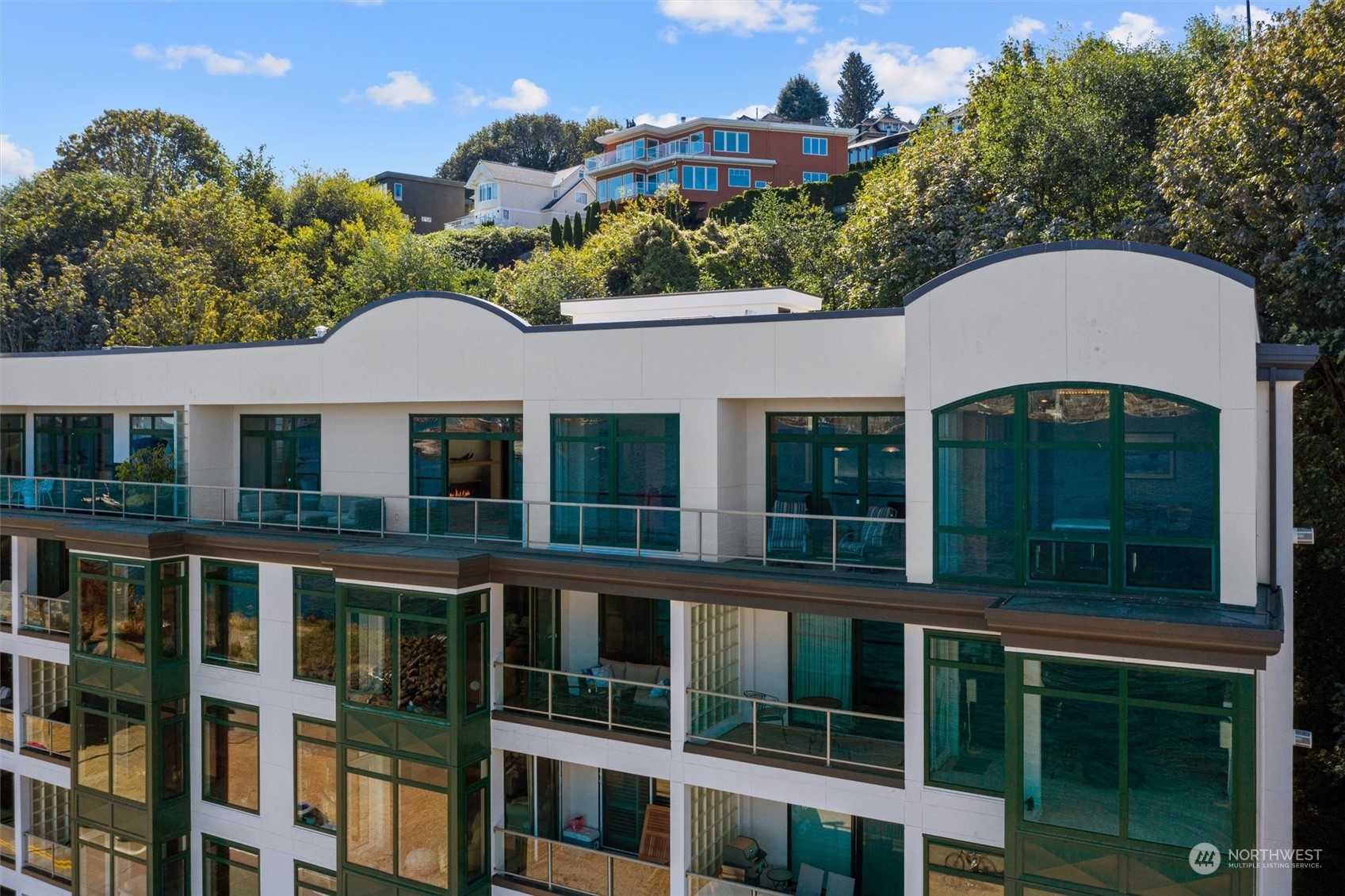 1661 Harbor Avenue Southwest, Unit 600 Seattle, WA 98126 - Photo 36 of 40 a view of a white house with large windows and a small yard