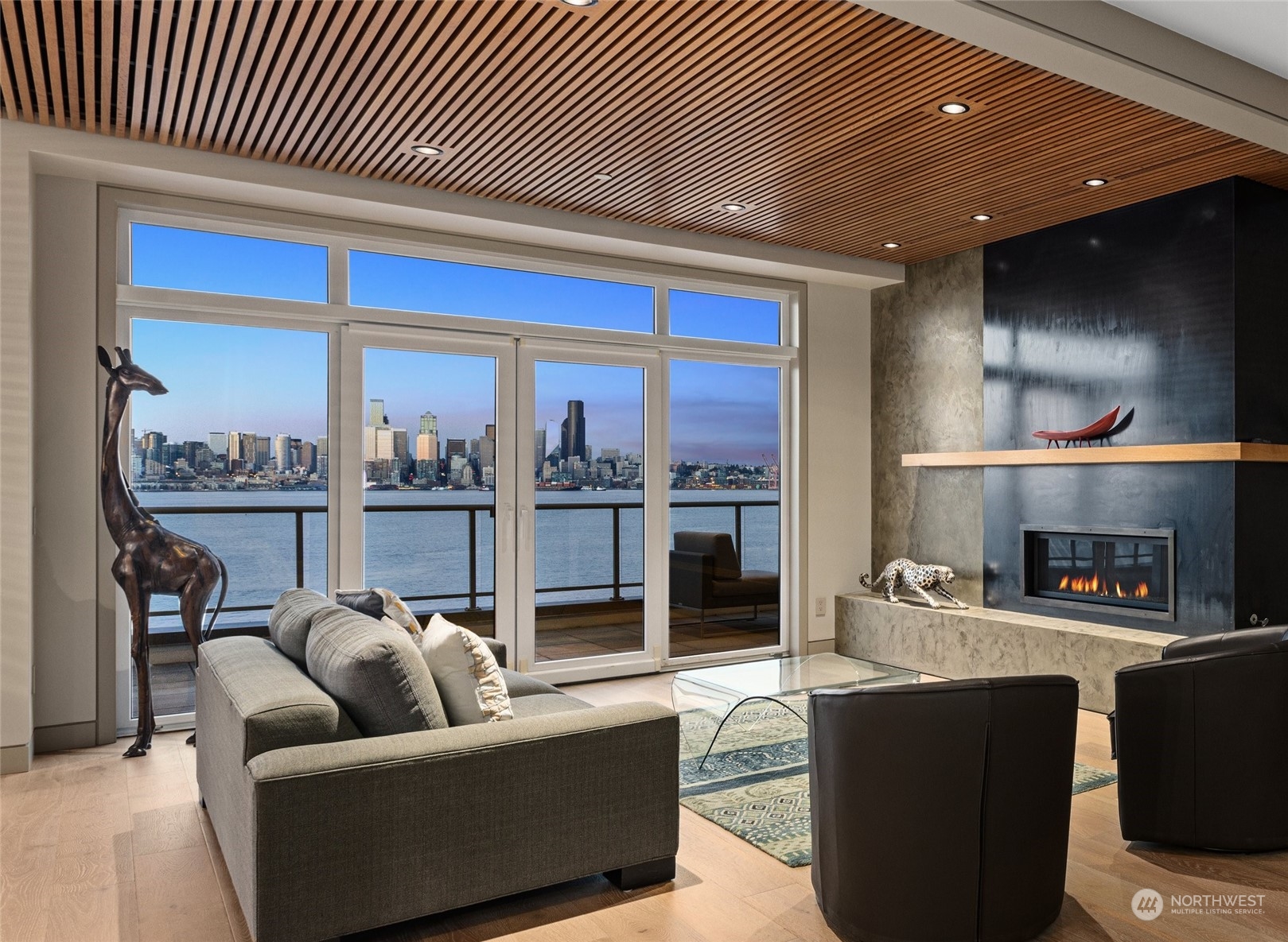 1661 Harbor Avenue Southwest, Unit 600 Seattle, WA 98126 - Photo 4 of 40 a living room with furniture a fireplace and a floor to ceiling window