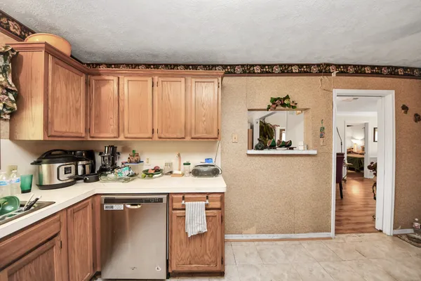 a kitchen with sink refrigerator and microwave