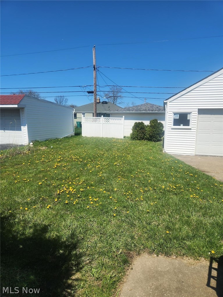 15901 Turney Road Maple Heights, OH 44137 - Photo 21 of 22 View of yard featuring an outdoor structure and a garage