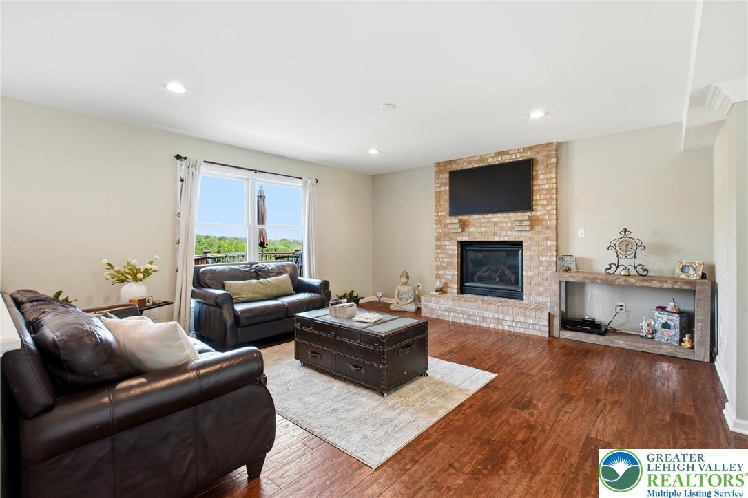 115 West Butternut Road Hellertown, PA 18055 - Photo 24 of 97 Hardwood floors and a brick fireplace create a cozy, inviting atmosphere.