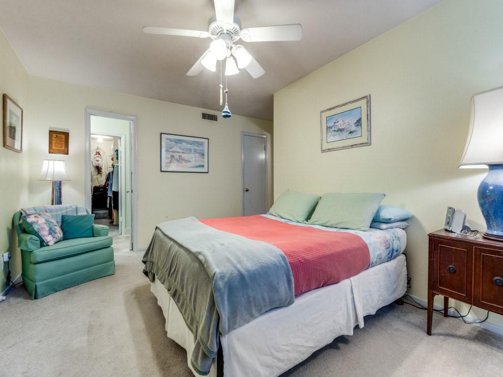 10755 Villager Road, Unit B Dallas, TX 75230 - Photo 11 of 24 a bedroom with a bed and a chandelier