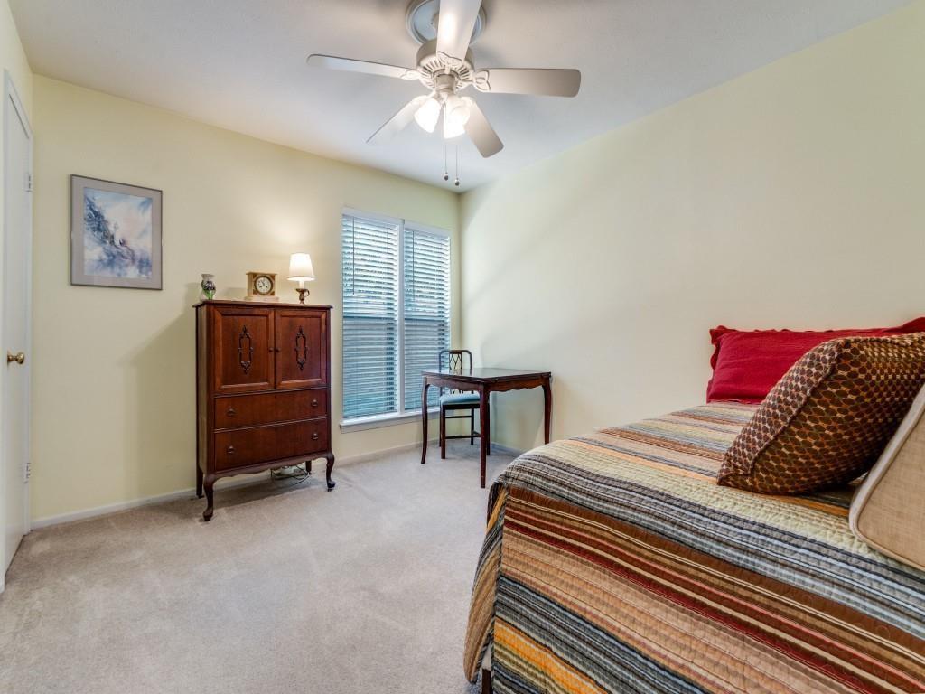 10755 Villager Road, Unit B Dallas, TX 75230 - Photo 14 of 24 a bedroom with a bed and a chandelier