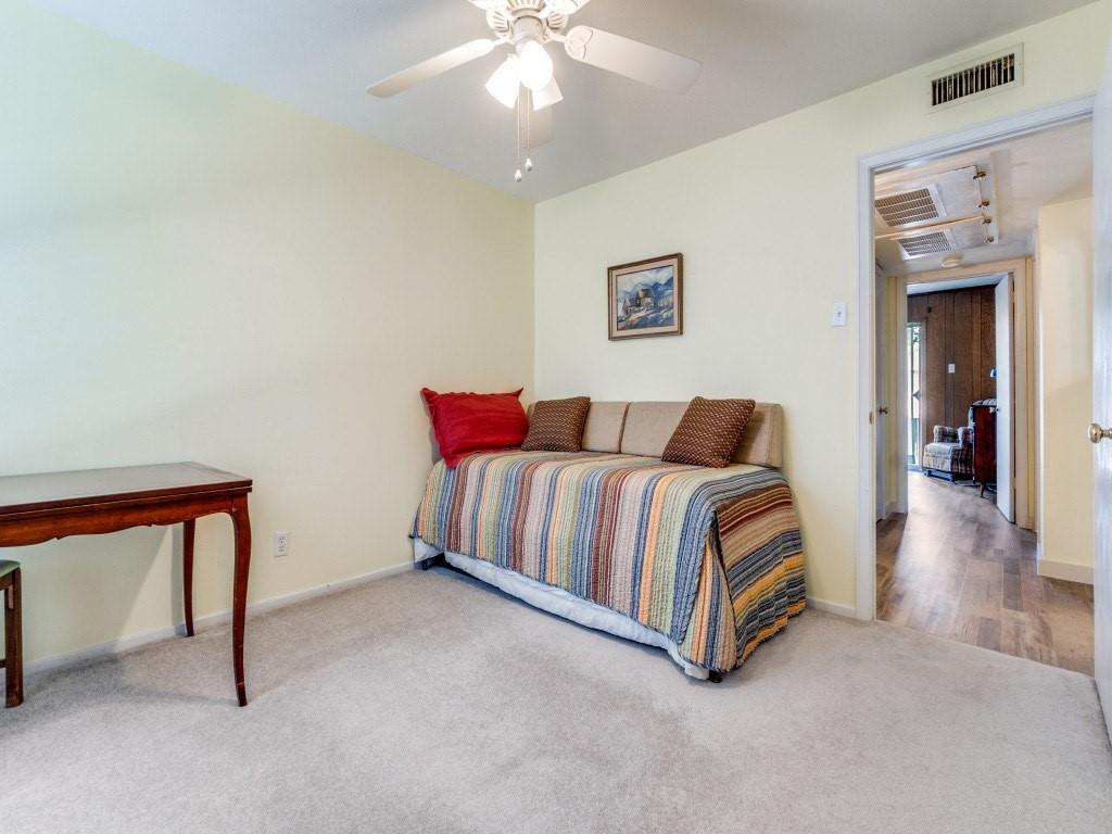 10755 Villager Road, Unit B Dallas, TX 75230 - Photo 15 of 24 a living room with furniture and a chandelier