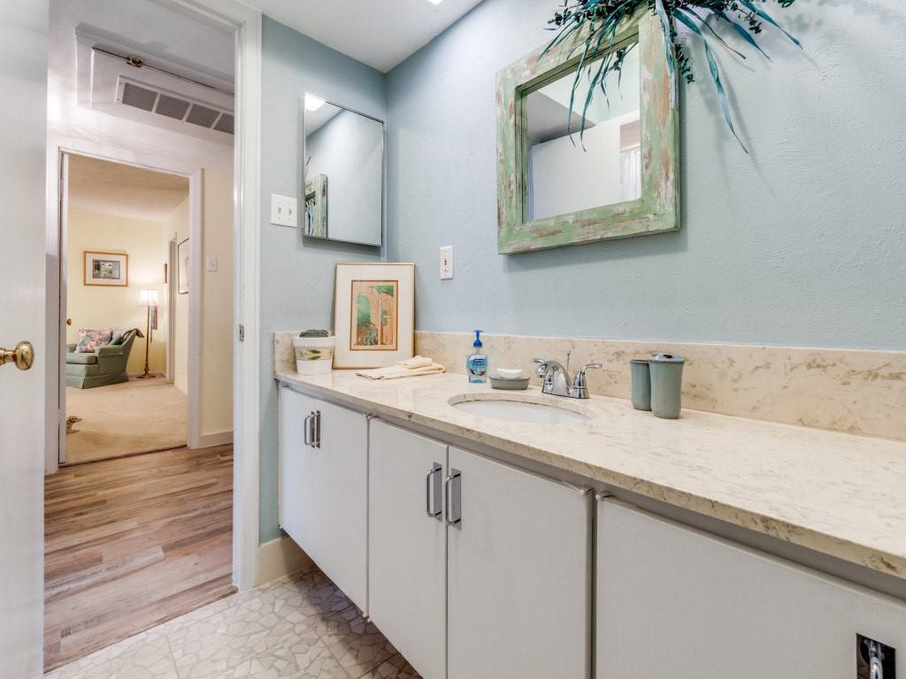 10755 Villager Road, Unit B Dallas, TX 75230 - Photo 16 of 24 a bathroom with a sink and a mirror