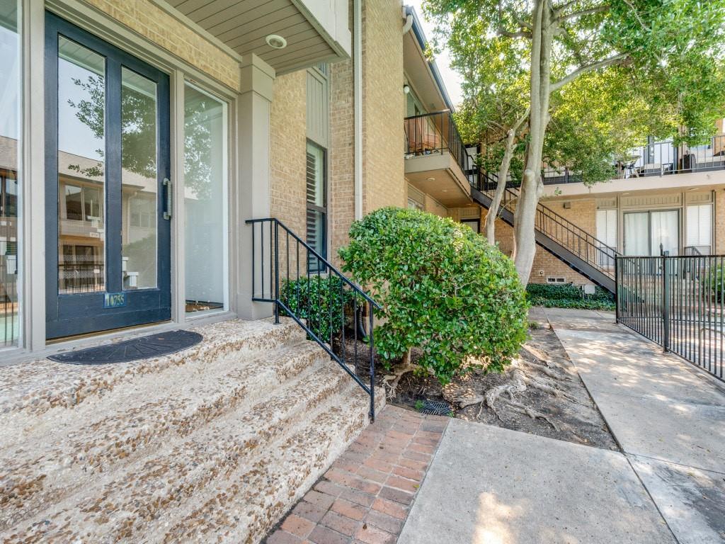 10755 Villager Road, Unit B Dallas, TX 75230 - Photo 17 of 24 a front view of a house with a yard and fountain