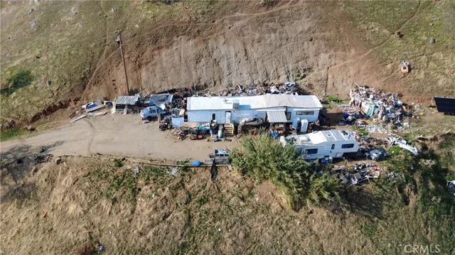 an aerial view of a house with a yard and sitting area