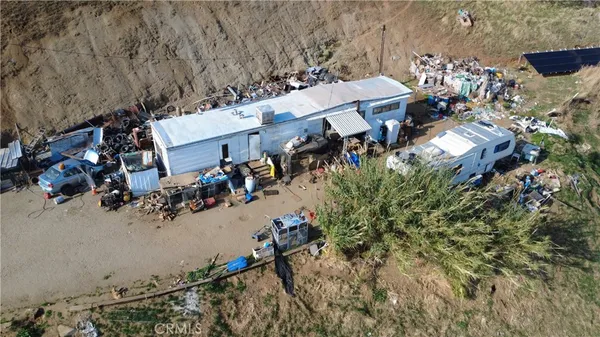 an aerial view of a house with a yard and swimming pool
