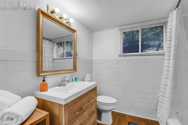 a bathroom with a sink toilet and mirror