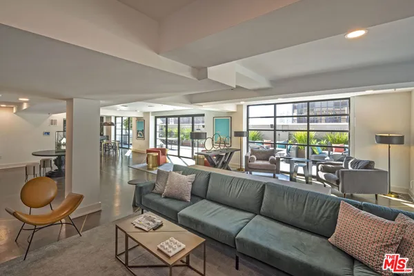 a living room with furniture and a floor to ceiling window