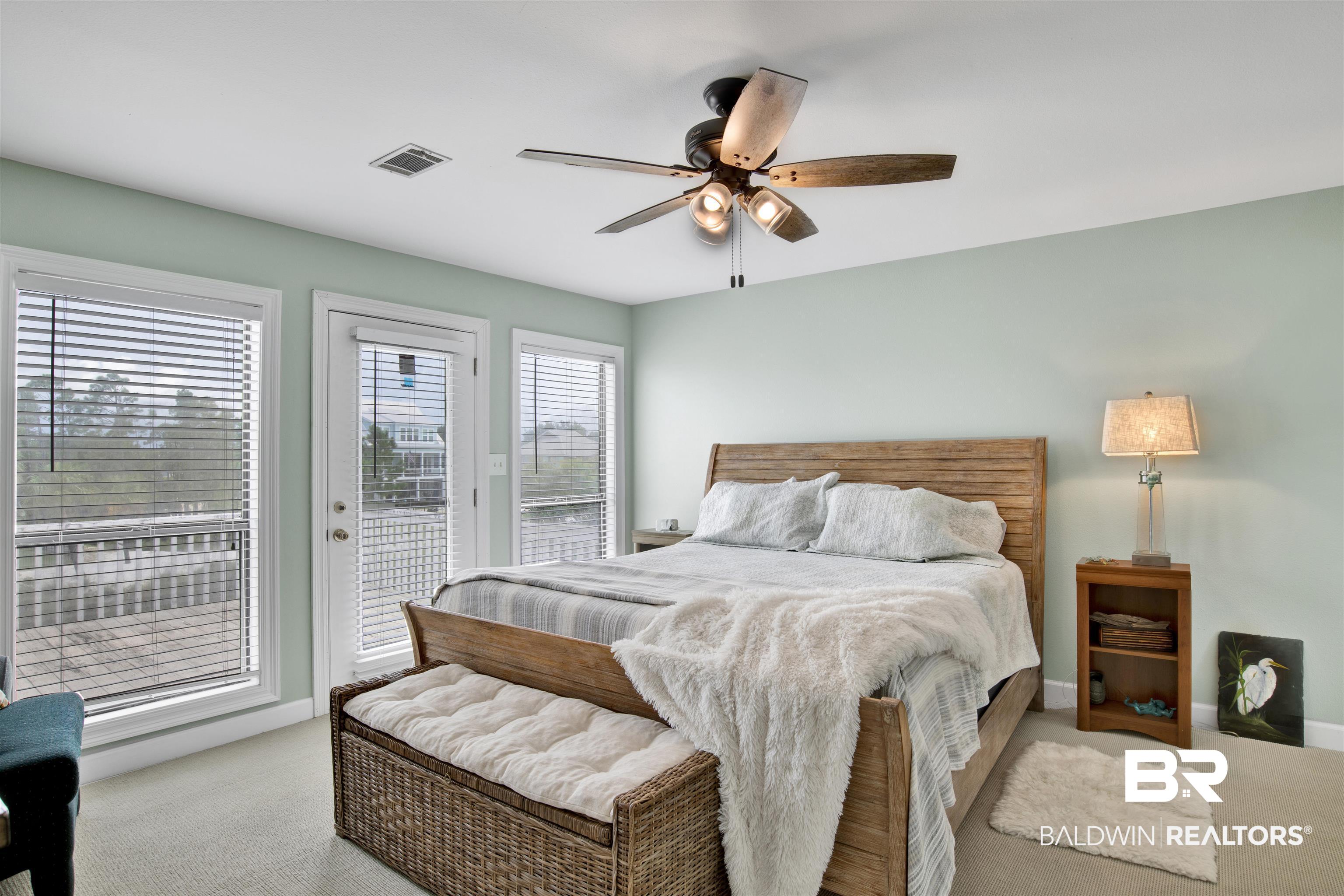 33093 River Road Orange Beach, AL 36561 - Photo 12 of 30 Bedroom featuring access to exterior, light colored carpet, multiple windows, and ceiling fan