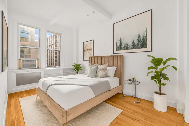 a bedroom with bed and a window