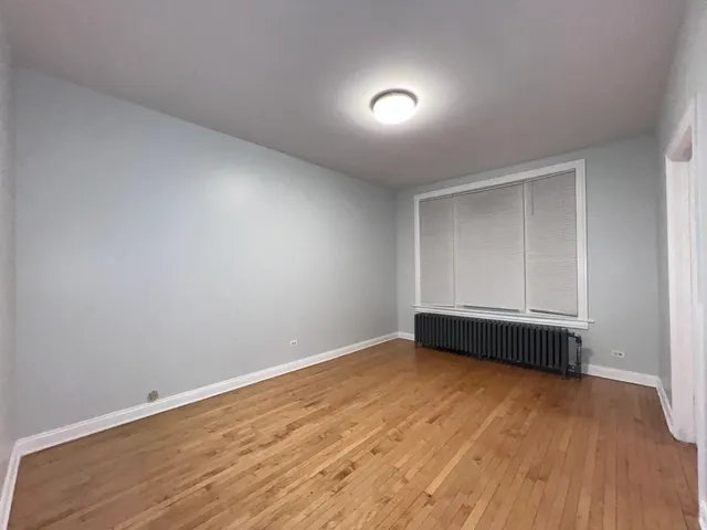 a view of an empty room and wooden floor