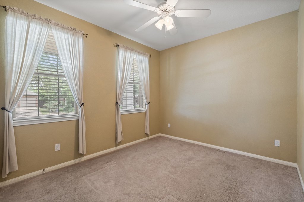 347 Spring Drive Kyle, TX 78640 - Photo 25 of 40 Well-lit room with ample natural light and a comforting overhead fan.