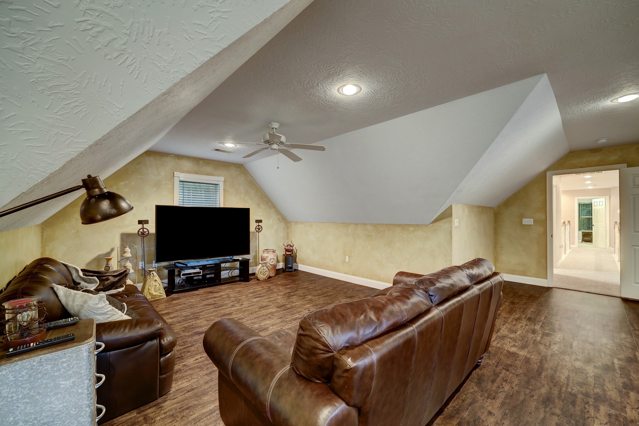 2949 Hargraves Road Huffman, TX 77336 - Photo 13 of 34 a living room with furniture and a flat screen tv
