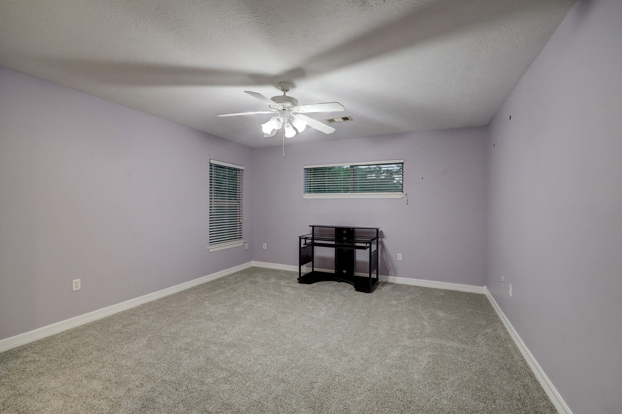 2949 Hargraves Road Huffman, TX 77336 - Photo 18 of 34 an empty room with windows and fan