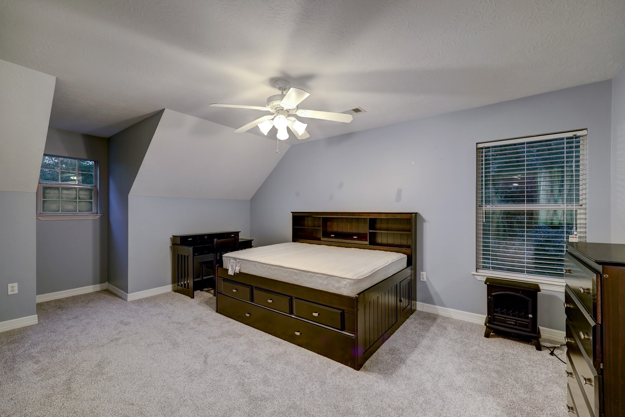 2949 Hargraves Road Huffman, TX 77336 - Photo 19 of 34 a spacious bedroom with a bed and a chandelier