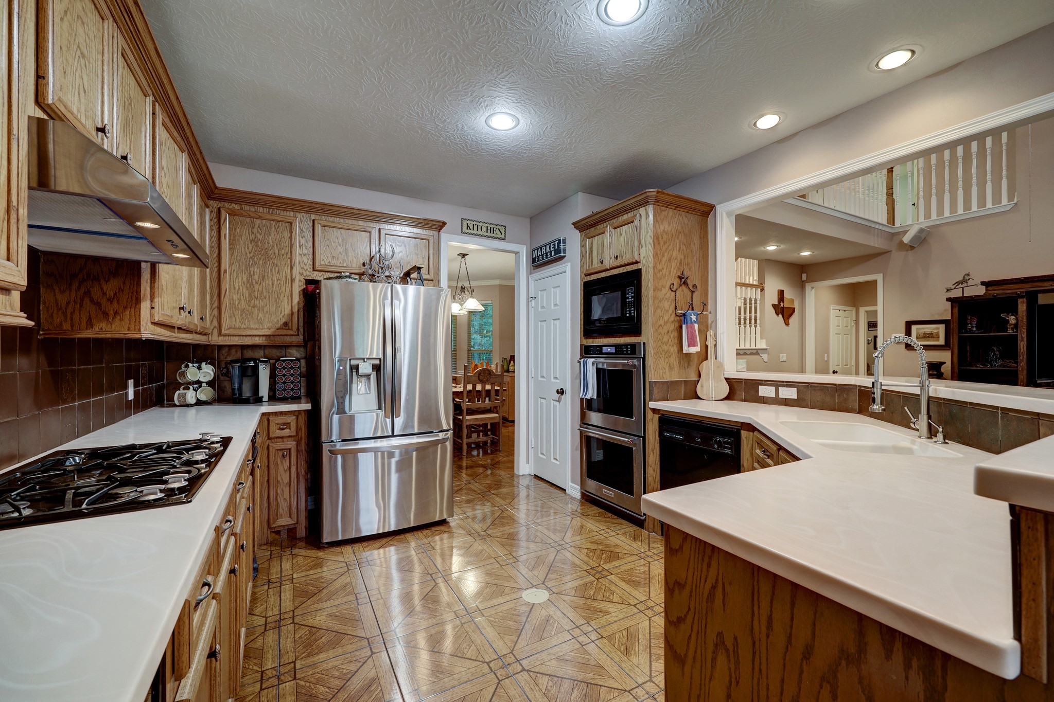 2949 Hargraves Road Huffman, TX 77336 - Photo 8 of 34 a kitchen with refrigerator a stove and cabinets