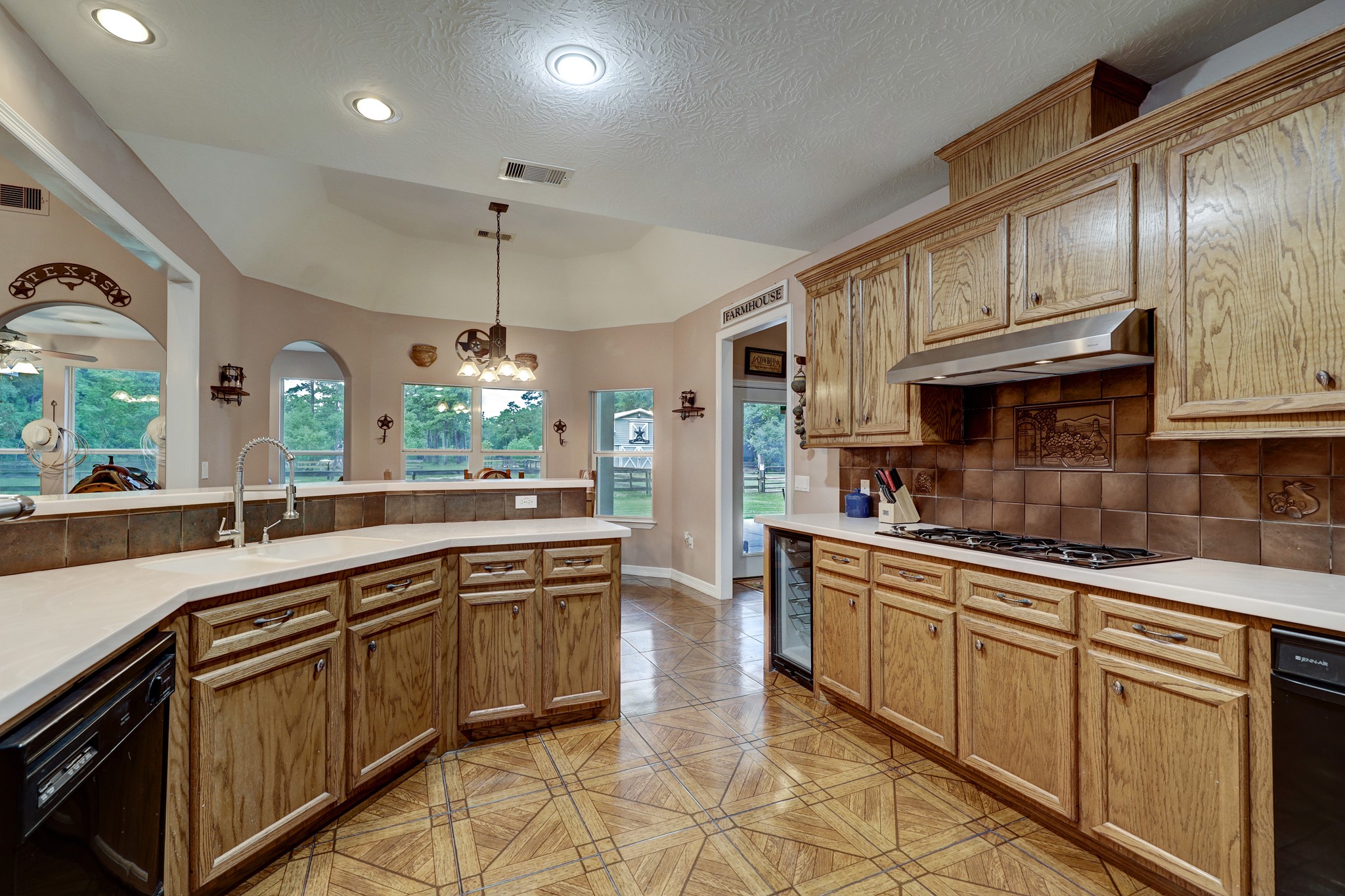 2949 Hargraves Road Huffman, TX 77336 - Photo 9 of 34 a kitchen with stainless steel appliances granite countertop a sink a stove and cabinets